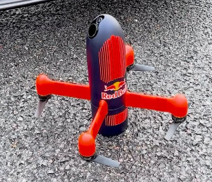 Red Bull Drone 1, with 4 thrusters extending from the sides of a small rocket shaped drone 